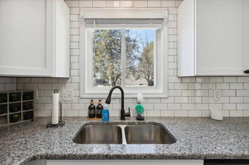 a kitchen counter with a sink and a window at Pet-Friendly Large-Group Oasis in Bay City
