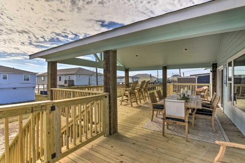 a wooden deck with a table and chairs on it at Surfside Beach Vacation Rental with Ocean Views in Freeport