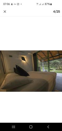 a bedroom with a bed with a pillow on it at Explore Sinharaja Rain Forest Tour Camp in Dombagoda