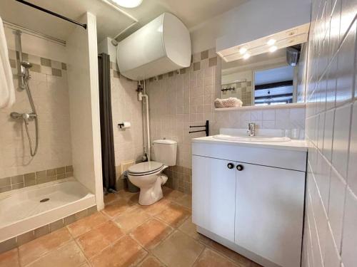 a bathroom with a toilet and a sink and a shower at Virée à deux in Riez