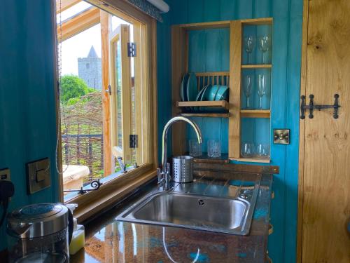 a kitchen with a sink and a window at Dôl Swynol Glamping Luxury cabin with outdoor bath in Aberystwyth