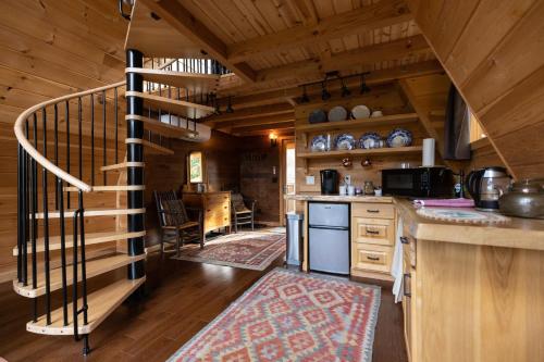 a kitchen with a spiral staircase in a cabin at Willow 