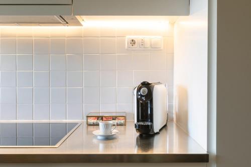 a coffee machine sitting on a counter in a kitchen at Urban Apartment Casa da Portela in Porto
