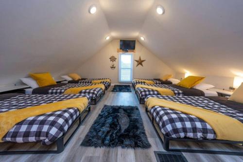 a attic room with four beds in it at Family Beach Retreat w/Fun Loft Space, Firepit in Michigan City