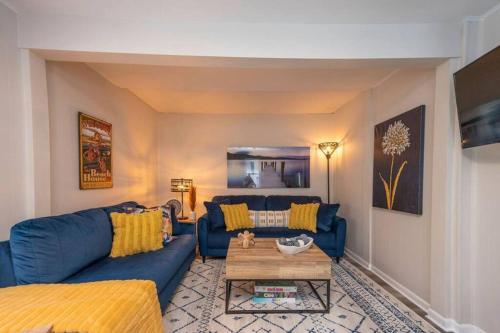 a living room with a blue couch and a table at Family Beach Retreat w/Fun Loft Space, Firepit in Michigan City