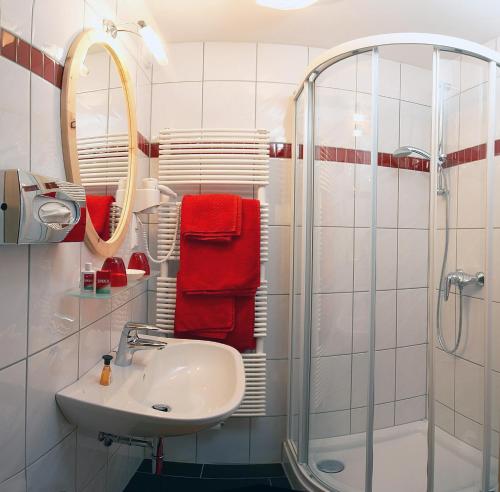 a bathroom with a sink and a shower at Pension & Appartements Ronacherhof -Mountain Hideaway Slopeside in Bad Kleinkirchheim