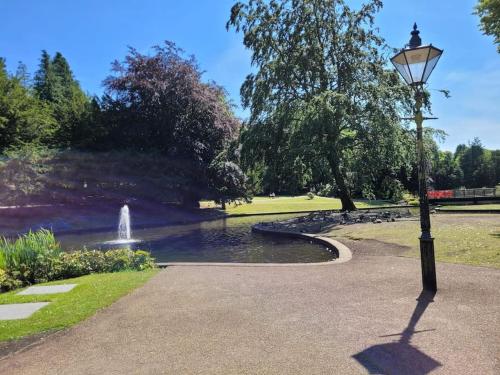 a street light in a park with a fountain at Contemporary 1 Bed Apartment, In Central Buxton in Buxton
