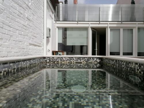 a pool of water in the middle of a building at Casa do Lado - The next door in Seixal