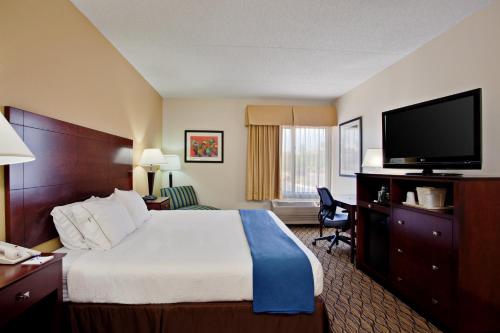 a hotel room with a bed and a flat screen tv at Holiday Inn Express Scottsdale North, an IHG Hotel in Scottsdale
