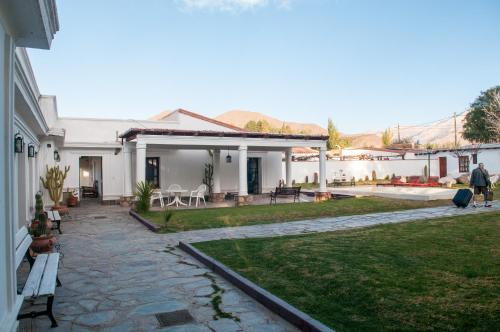 a house with a stone walkway and a yard at Tampu in Cachí