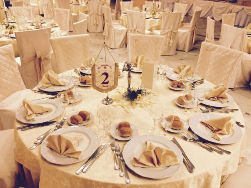 a table with white plates and napkins on it at Grand Hotel Stella Maris Italia in Palmi