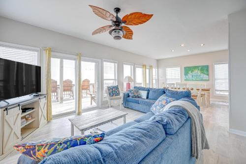 a living room with a blue couch and a tv at Seashore's Best in North Topsail Beach