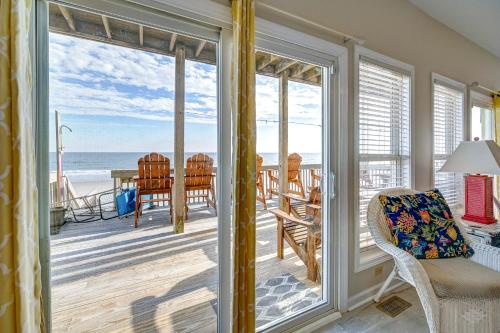 a room with a balcony with a view of the ocean at Seashore's Best in North Topsail Beach