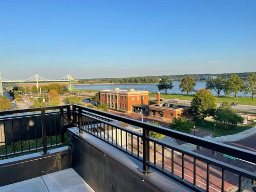 a balcony with a view of the river and a bridge at River Front Luxury Furnished Studio Downtown QC in Davenport