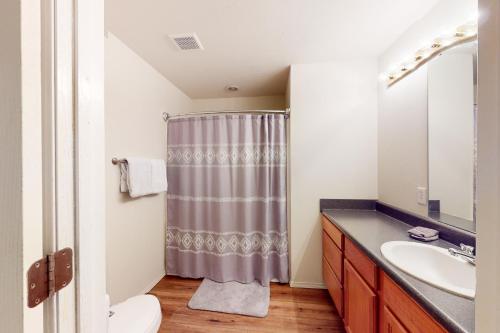 a bathroom with a shower curtain and a sink at Tanner's Retreat in Branson