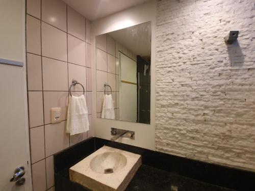a bathroom with a sink and a mirror at Apartamento Caruaru in Caruaru