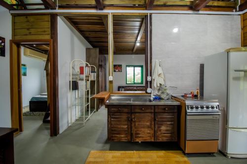 a kitchen with a sink and a stove at Casa do Tesouro in Joinville