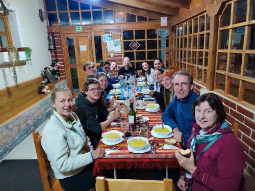 a group of people sitting at a long table at Cuscungo Cotopaxi Hostel & Lodge in Chasqui