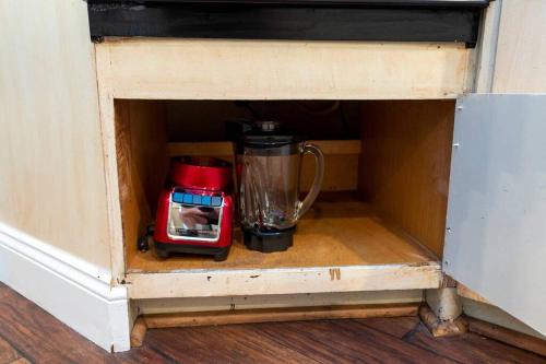 a coffee maker and a blender in a wooden cabinet at Close to Beach, Hot Tub, Pet Friendly, Firepit in Michigan City