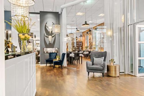 a restaurant with chairs and tables in a room at Best Western Hotel Herman Bang in Frederikshavn