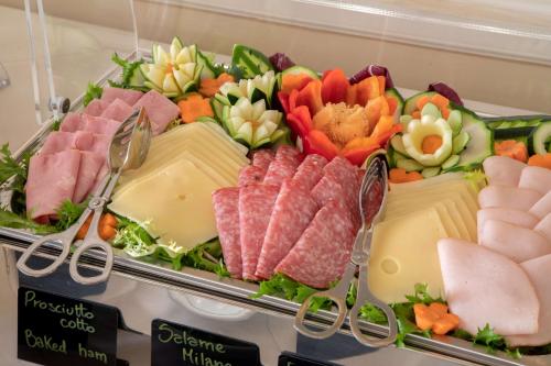 a tray of different types of meats and cheese at Hotel Canada, BW Premier Collection in Rome