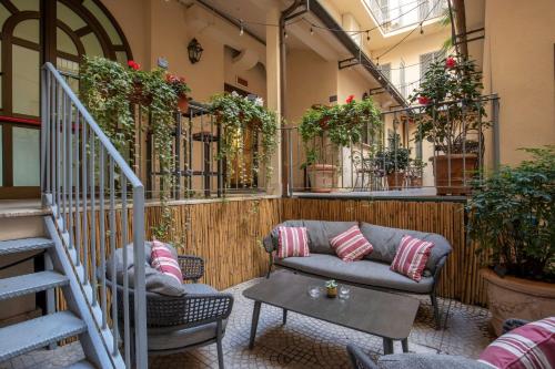 a living room with a couch and some plants at Hotel Canada, BW Premier Collection in Rome