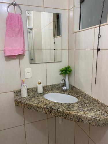 a bathroom counter with a sink and a mirror at Village Itacimirim in Camaçari