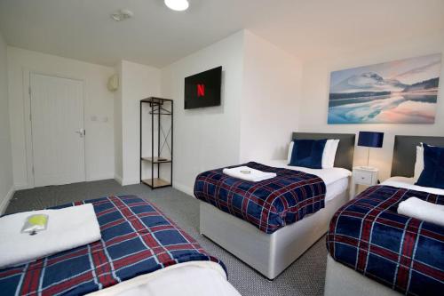 a hotel room with two beds and a tv at Swan Studio Six - Coventry in Coventry