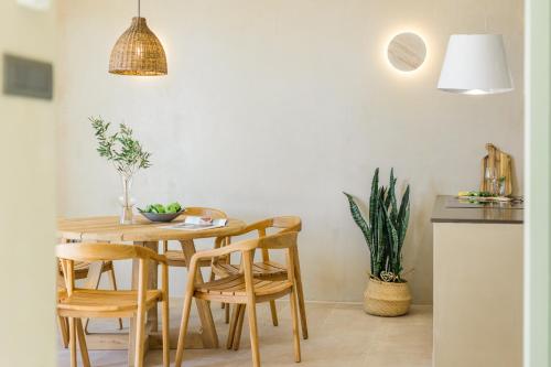 a dining room with a wooden table and chairs at Apeiron Villas in Kefallonia