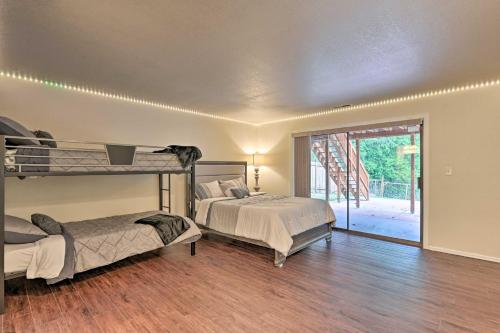 a bedroom with two bunk beds and a patio at Modern Home with Deck about 14 Mi to Downtown Seattle! in Shoreline