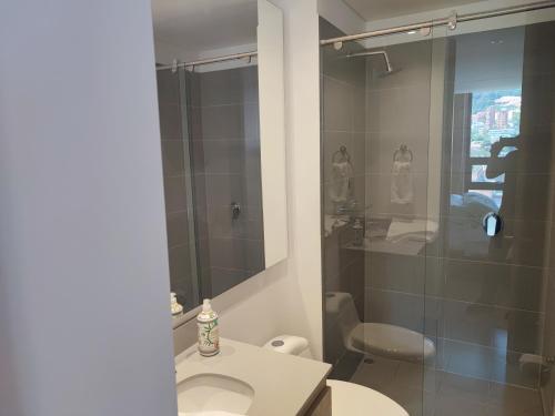 y baño con ducha, lavabo y aseo. en Aparta Suite - Centro Internacional - Mitika, en Bogotá