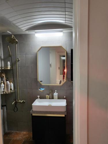 a bathroom with a sink and a mirror at Hangang River view Apartment in Seoul