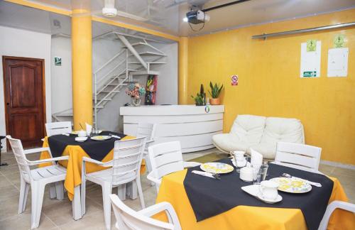 a dining room with two tables and a couch at Markasa Hotel boutique in Cartagena de Indias