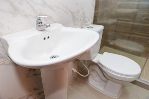 a bathroom with a white sink and a toilet at Markasa Hotel boutique in Cartagena de Indias