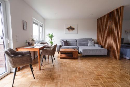 ein Wohnzimmer mit einem Sofa und einem Tisch in der Unterkunft WITTMANN Ganze Apartments in Gifhorn in Gifhorn