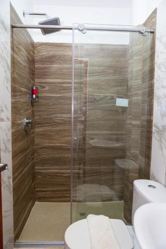 a glass shower in a bathroom with a toilet at Markasa Hotel boutique in Cartagena de Indias