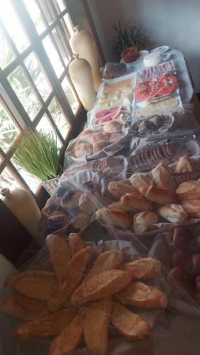 a group of sandwiches and breads on a table at 3 Palmeiras Guest Lounge in Miguel Pereira