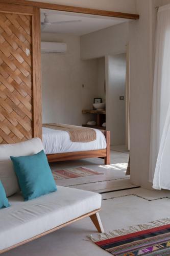 a living room with two beds and a couch at Casa Roni by Xeno - 5 Bedroom Luxury Villa with Ocean View in Playa Estacahuite