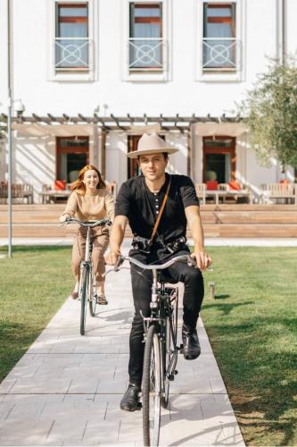 a man and woman riding bikes down a sidewalk at JW Marriott Venice Resort & Spa in Venice