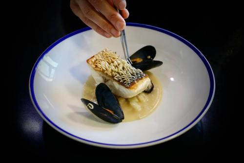 a person eating a piece of food on a plate at JW Marriott Venice Resort & Spa in Venice