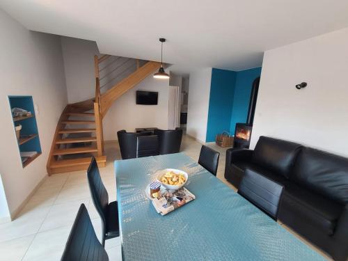 une table à manger et des chaises dans un salon dans l'établissement Maison de Charme avec Spa et Véranda - Proche Thermes de Vittel et Cité des Images - FR-1-589-252, à Velotte-et-Tatignécourt