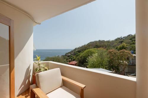 a balcony with a view of the ocean at Casa Roni by Xeno - 5 Bedroom Luxury Villa with Ocean View in Playa Estacahuite