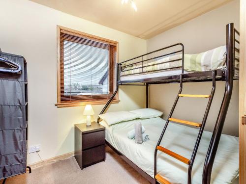 a bedroom with two bunk beds and a window at Dorrey View Cottage - Uk39010 in Halkirk