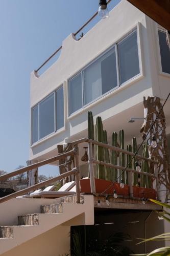 a house with a cactus in front of it at Casa Roni by Xeno - 5 Bedroom Luxury Villa with Ocean View in Playa Estacahuite