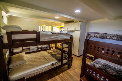 a room with three bunk beds in it at Hotel Hacienda San Isidro in Belén de Umbría
