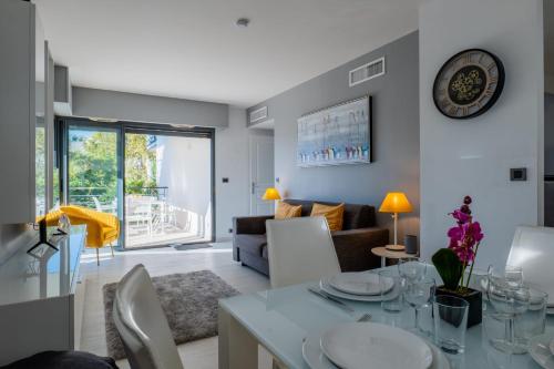 cocina y sala de estar con mesa y sillas en SERRENDY 2-bedroom- with terrace & pool, en Cannes
