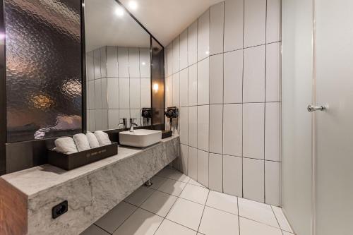 a bathroom with a sink and a mirror at Brown Dot Hotel Seosan in Seosan