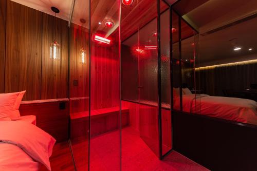 a red room with two beds and a mirror at Brown Dot Hotel Seosan in Seosan