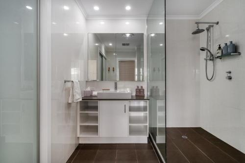 a bathroom with a sink and a shower at Nimolanca - 3 Bedroom Partial Ocean View in Caloundra
