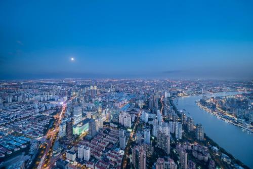 an aerial view of a large city with a river at Park Hyatt Shanghai in Shanghai